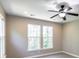 Bedroom with neutral paint, gray carpet, and large windows, with ceiling fan at 225 Slipper Shell Ct, Mount Pleasant, SC 29464