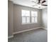 Neutral bedroom features carpet floors, a ceiling fan, and two large windows with white shutters at 225 Slipper Shell Ct, Mount Pleasant, SC 29464