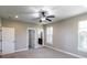 Bedroom with neutral paint, gray carpet, large windows, with adjacent bathroom and closet at 225 Slipper Shell Ct, Mount Pleasant, SC 29464