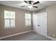 Bedroom features carpet floors, a ceiling fan, two large windows with white shutters, and a closet at 225 Slipper Shell Ct, Mount Pleasant, SC 29464
