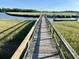 Wooden boardwalk leading to a private dock overlooking scenic marsh views at 225 Slipper Shell Ct, Mount Pleasant, SC 29464