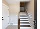 Bright entryway with staircase featuring dark wood treads and white risers, leading to the upper level at 225 Slipper Shell Ct, Mount Pleasant, SC 29464