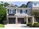 Charming townhome featuring brick accents, a two-car garage, and manicured landscaping for curb appeal at 225 Slipper Shell Ct, Mount Pleasant, SC 29464