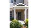 Inviting brick front porch with columns and landscaping, enhancing the curb appeal of this charming home at 225 Slipper Shell Ct, Mount Pleasant, SC 29464