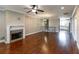 Inviting living room featuring a fireplace, hardwood floors, and an open layout connecting to the kitchen at 225 Slipper Shell Ct, Mount Pleasant, SC 29464