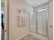 Bathroom with a glass-enclosed shower, tiled floors, and a convenient towel rack at 227 Spectrum Rd, Summerville, SC 29486