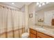 Well-lit bathroom with a granite vanity, coordinating fixtures, and a shower with a decorative curtain at 227 Spectrum Rd, Summerville, SC 29486