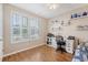 Well-lit bedroom featuring a desk, built-in shelves, and a large window with blinds at 227 Spectrum Rd, Summerville, SC 29486