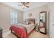 Bedroom with a ceiling fan, large windows, and a full-length mirror at 227 Spectrum Rd, Summerville, SC 29486