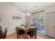 Dining room with elegant chandelier, wood floors, and access to outdoor patio at 227 Spectrum Rd, Summerville, SC 29486
