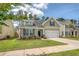 Well-kept home featuring a green lawn and symmetrical landscaping design at 227 Spectrum Rd, Summerville, SC 29486