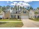 Well-maintained home with a neat front yard, a two-car garage, and classic curb appeal at 227 Spectrum Rd, Summerville, SC 29486
