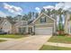 Charming home with a manicured lawn, flower beds, and a two-car garage at 227 Spectrum Rd, Summerville, SC 29486
