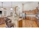 Spacious kitchen with center island, granite counters, stainless appliances, and wood floors at 227 Spectrum Rd, Summerville, SC 29486