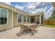 Spacious patio featuring an outdoor dining set next to a screened-in porch at 227 Spectrum Rd, Summerville, SC 29486