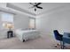 Bright bedroom featuring a tray ceiling, ceiling fan, and two windows dressed with blinds at 2292 Skyler Dr, Mount Pleasant, SC 29466