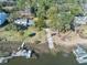 Aerial view of a waterfront home and dock with lush landscaping and mature trees at 231 Bayview Dr, Mount Pleasant, SC 29464