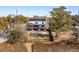 Aerial view of a modern home with a luxurious backyard, pool, fire pit, and manicured lawn at 231 Bayview Dr, Mount Pleasant, SC 29464