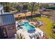 Aerial view of backyard featuring an in-ground pool, spa, fire pit, and patio with umbrella at 231 Bayview Dr, Mount Pleasant, SC 29464