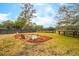 Large backyard featuring a fire pit with several wooden chairs surrounding it at 231 Bayview Dr, Mount Pleasant, SC 29464