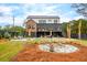 Stunning backyard featuring a modern home, pool, patio, fire pit, and manicured lawn at 231 Bayview Dr, Mount Pleasant, SC 29464