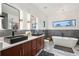 Modern bathroom featuring double vanity, soaking tub, shower, stylish fixtures and contemporary lighting at 231 Bayview Dr, Mount Pleasant, SC 29464