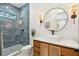 Modern bathroom featuring blue tiled shower and contemporary vanity with round mirror at 231 Bayview Dr, Mount Pleasant, SC 29464