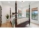 Bedroom with a four-poster bed, natural lighting, and a modern, minimalist decor at 231 Bayview Dr, Mount Pleasant, SC 29464