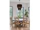 Bright dining area with modern chandelier, table, and chairs with view to the backyard at 231 Bayview Dr, Mount Pleasant, SC 29464