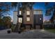 Modern home with mixed siding, metal roof, two-car garage, and covered entry stairs at 231 Bayview Dr, Mount Pleasant, SC 29464