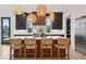 Kitchen island with seating, wicker pendant lights, and open to the rest of the home at 231 Bayview Dr, Mount Pleasant, SC 29464