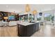 Kitchen island with seating overlooking the dining and living areas of this open-concept home at 231 Bayview Dr, Mount Pleasant, SC 29464