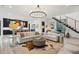 Living room featuring light wood floors, modern furniture, and an open layout to the kitchen at 231 Bayview Dr, Mount Pleasant, SC 29464