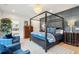 Spacious bedroom featuring a four-poster bed, seating area, wood trim, and modern decor at 231 Bayview Dr, Mount Pleasant, SC 29464
