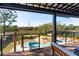 Relaxing porch with comfortable seating overlooking a beautiful backyard and in-ground pool at 231 Bayview Dr, Mount Pleasant, SC 29464
