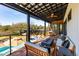 Outdoor porch with ample seating area overlooking the pool and lush backyard at 231 Bayview Dr, Mount Pleasant, SC 29464
