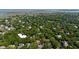 Wide aerial view of a residential neighborhood with homes surrounded by dense trees and waterways in the background at 24 Beachwood West, Isle of Palms, SC 29451