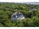Aerial view of a rear of a home surrounded by lush trees with a deck at 24 Beachwood West, Isle of Palms, SC 29451