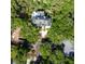 Expansive aerial view of a luxury home surrounded by lush trees, highlighting its expansive outdoor space at 24 Beachwood West, Isle of Palms, SC 29451