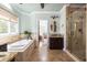 Spa-like bathroom with a soaking tub, glass shower, and vanity with granite countertops at 24 Beachwood West, Isle of Palms, SC 29451