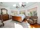 Tranquil bedroom with skylights, ceiling fans, and a cozy seating area by the windows at 24 Beachwood West, Isle of Palms, SC 29451