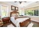Comfortable bedroom features hardwood floors, a ceiling fan, and many windows with shades at 24 Beachwood West, Isle of Palms, SC 29451