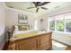 Charming bedroom features a decorative ceiling fan and a large window that allows natural light at 24 Beachwood West, Isle of Palms, SC 29451