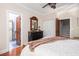 Cozy bedroom with hardwood floors, dark wood doors and ceiling fan at 24 Beachwood West, Isle of Palms, SC 29451