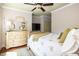 Bright bedroom with ceiling fan, dresser with large mirror, and a comfortable bed with stylish bedding at 24 Beachwood West, Isle of Palms, SC 29451
