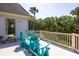 Outdoor deck with Adirondack chairs and views of the surrounding greenery at 24 Beachwood West, Isle of Palms, SC 29451