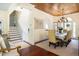 Formal dining room features hardwood floors, wood ceiling, and table with seating, with stairs nearby at 24 Beachwood West, Isle of Palms, SC 29451