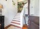 The entryway with wooden floors offers access to multiple levels in the house, and the decor is light and airy at 24 Beachwood West, Isle of Palms, SC 29451