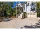 Inviting two-story home with a grand staircase, manicured landscaping, and a convenient two-car garage at 24 Beachwood West, Isle of Palms, SC 29451