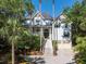 Charming two-story home features a well-manicured lawn, a two-car garage, and plentiful trees offering shade and privacy at 24 Beachwood West, Isle of Palms, SC 29451
